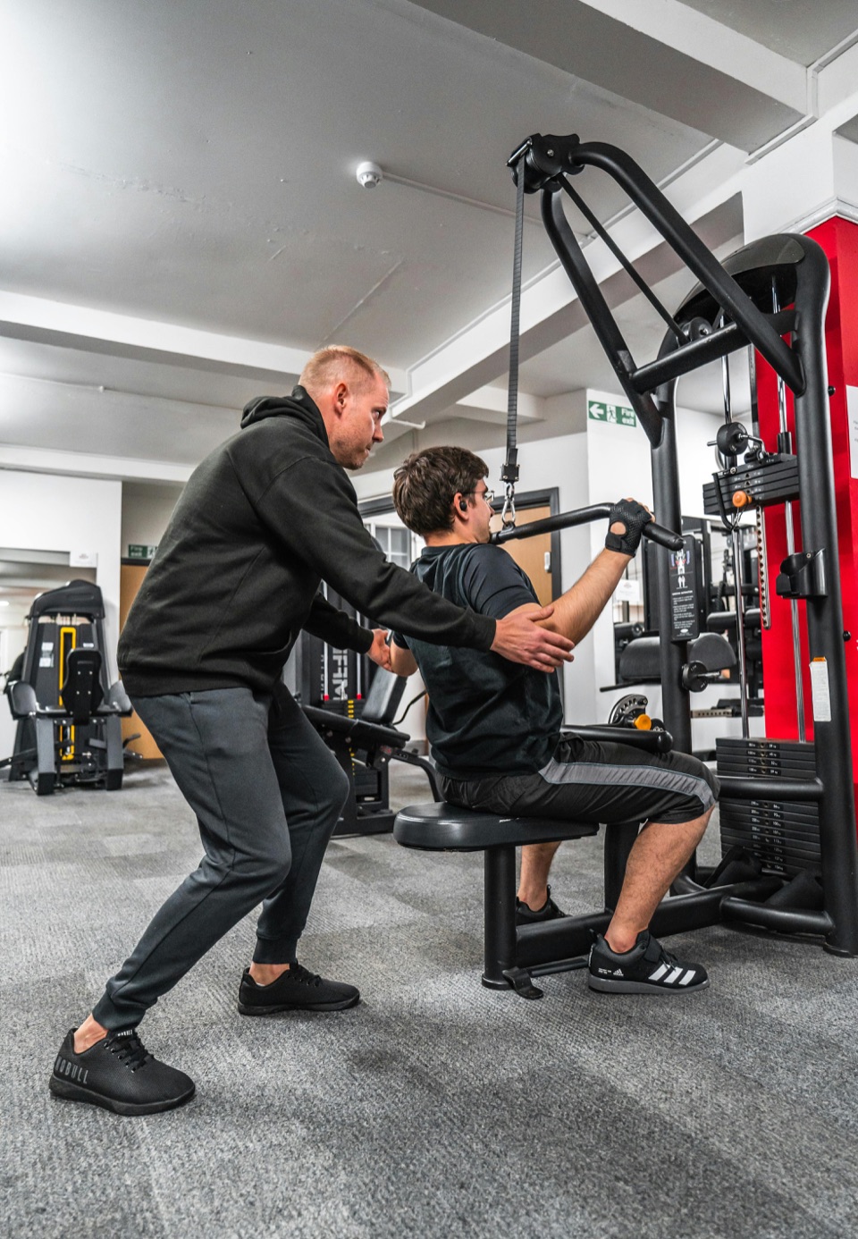 Coach guiding a client through a premium personal training session.